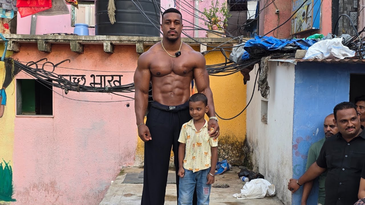 Ashton Hall spending time with a young member of the community